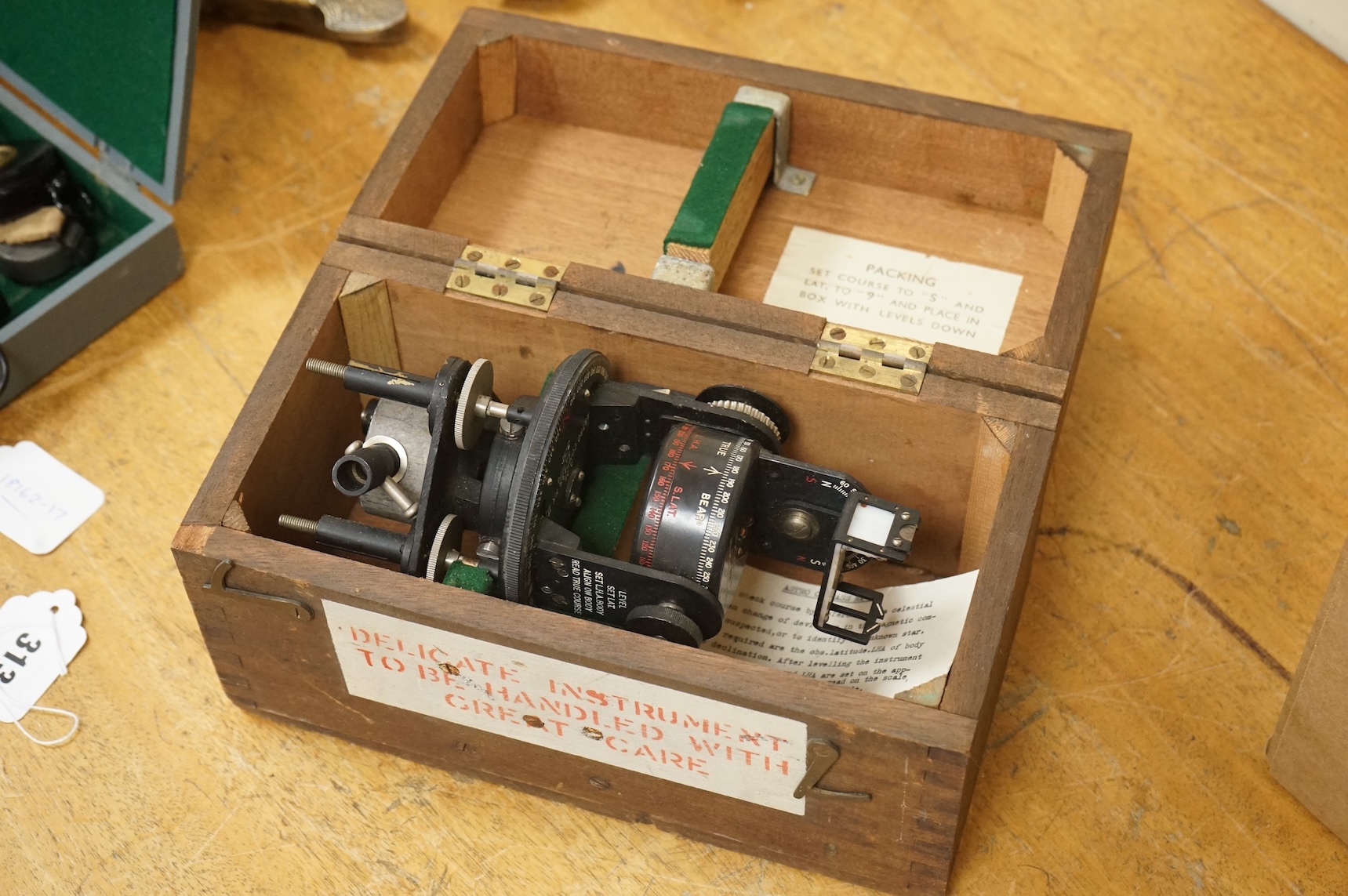 A WWII cased RAF Air Ministry Astro Compass MKII, the inside lid of the case stamped examined 24 March 1943, case dimensions 16.5cm wide, 16cm high, 13.5cm deep